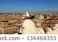 Seagull on the outlook above historical center of Rome. Seagull stands over the roofs of Roma. Seagull watching Rome in summer. Bird on rooftops in the historic city center. 136468355