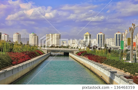 Ashgabat, Turkmenistan - September 26, 2017: Modern architecture of Ashgabat. New apartamentes behind a young park with fountain complex. Ashgabat is the capital of Turkmenistan. Ashgabat, Turkmenistan - September 26, 2017: Modern architecture of Ashgabat. New apartamentes behind a young park with fountain complex. Ashgabat is the capital of Turkmenistan. 136468359