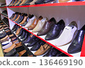 Ashgabat, Turkmenistan market - Mart 15.2022: Shelves in a store with a variety of men's shoes 136469190