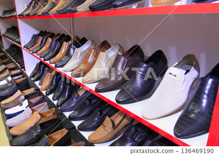 Ashgabat, Turkmenistan market - Mart 15.2022: Shelves in a store with a variety of men's shoes 136469190