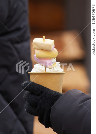 Warm Winter Marshmallow Skewers in Cup Held by Gloved Hand on a Cold Day Warm Winter Marshmallow Skewers in Cup Held by Gloved Hand on a Cold Day 136470678