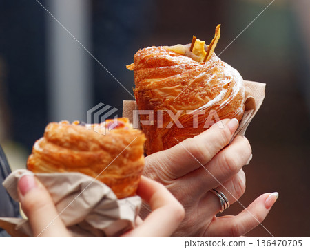 Two Flaky Croissants Held by Hands With Napkins, Fresh Morning Breakfast Snack Delight Two Flaky Croissants Held by Hands With Napkins, Fresh Morning Breakfast Snack Delight 136470705