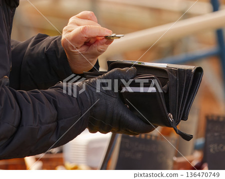 Customer Paying with Coins at Market Stall 136470749