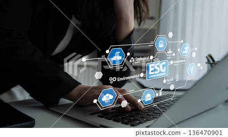 Business Professional Engaging with ESG Concepts on Laptop, Highlighting Environmental, Social, and Governance Factors for Sustainable Development. Tessel 136470901
