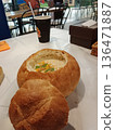 Creamy soup in bread bowl with extra roll. 136471887
