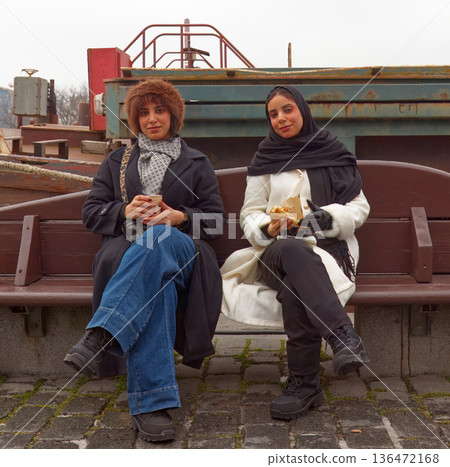 Middle Eastern tourists enjoying street food at Naplavka market in Prague 136472168