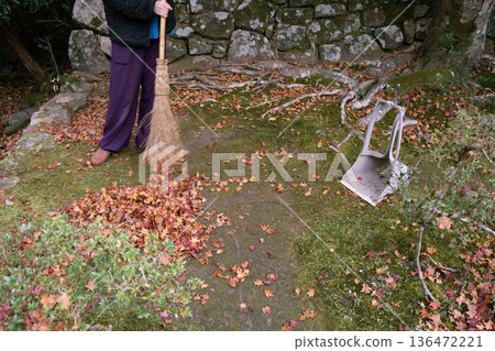 Temple workers cleaning autumn leaves Temple workers cleaning autumn leaves 136472221