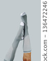 upside down man wearing gray compression socks 136472246