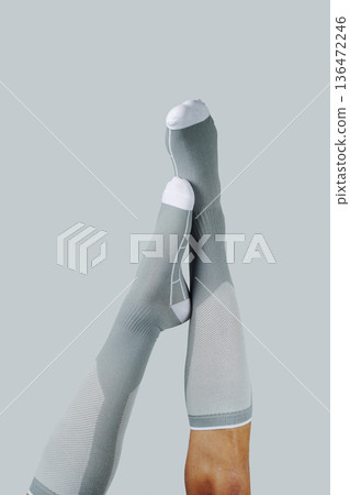 upside down man wearing gray compression socks upside down man wearing gray compression socks 136472246