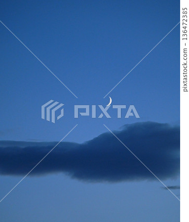 The moon floating above the clouds at dusk in autumn The moon floating above the clouds at dusk in autumn 136472385