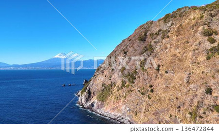 The steep cliffs of Ida in Nishiizu and snow-capped Mount Fuji seen across Suruga Bay | The dynamic topography of Izu Peninsula Geopark The steep cliffs of Ida in Nishiizu and snow-capped Mount Fuji seen across Suruga Bay | The dynamic topography of Izu Peninsula Geopark 136472844