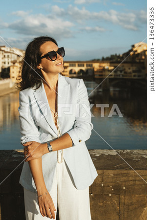 Confident Woman Enjoying City View by the River 136473336