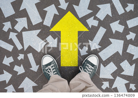 Forward arrow - legs with trainer shoes Forward arrow - legs with trainer shoes 136474809