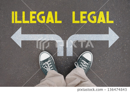 Legal or illegal concept - legs with trainer shoes Legal or illegal concept - legs with trainer shoes 136474843