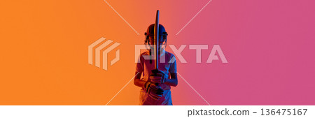 Cricket batsman standing front view with bat upright in neon studio. Banner Cricket batsman standing front view with bat upright in neon studio. Banner 136475167