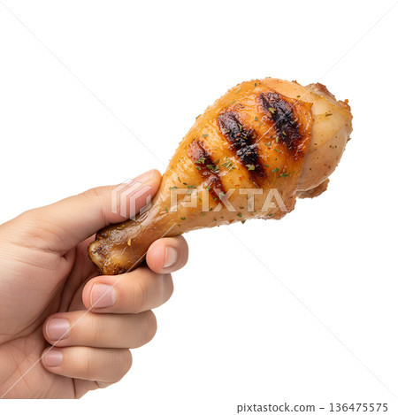 Hand holding grilled, golden-brown chicken drumstick with crispy skin, isolated. Ideal for barbecue, comfort food, and summer cookouts Hand holding grilled, golden-brown chicken drumstick with crispy skin, isolated. Ideal for barbecue, comfort food, and summer cookouts 136475575