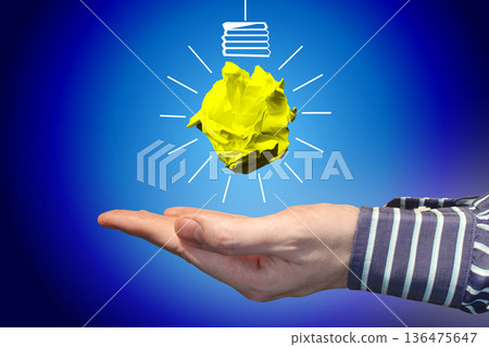 Light bulb icon made with crumpled paper and human hand - idea, creativity concept 136475647