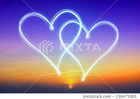 Two heart shapes on sunset sky - love concept Two heart shapes on sunset sky - love concept 136475805