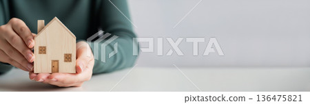 Home ownership background with woman hands protecting house icon. Family housing and investment mockup. Home ownership background with woman hands protecting house icon. Family housing and investment mockup. 136475821