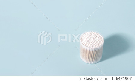 White cotton swabs with wooden sticks for hygiene on blue background 136475907