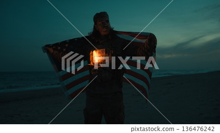 Patriotism of an American soldier during Memorial Day With flag at night 136476242