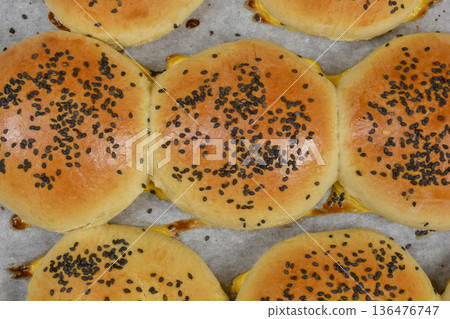 Top view of freshly baked buns with black sesame seeds 136476747