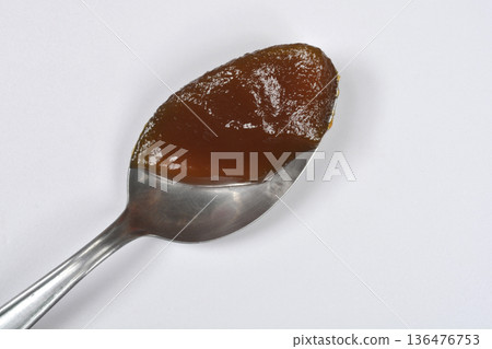 Spoonful of apricot jam on white background Spoonful of apricot jam on white background 136476753