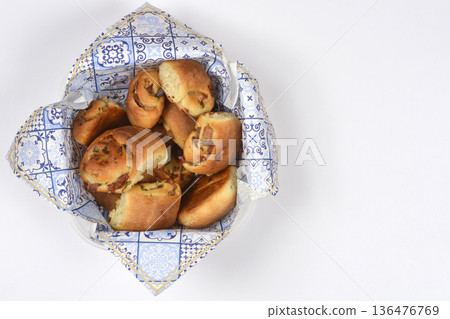 Baked bread rolls with prosciutto in a basket Baked bread rolls with prosciutto in a basket 136476769