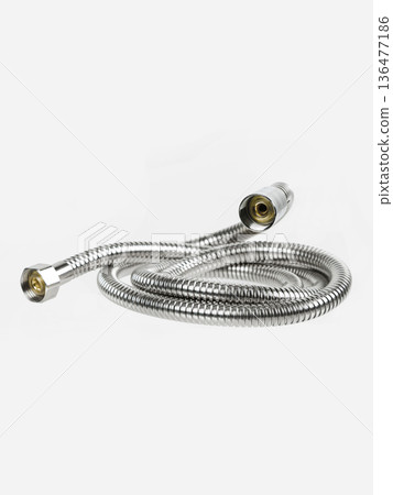 Shower hose is insulated on a white background. The hose is flexible, metal, chrome-plated. Shower hose is insulated on a white background. The hose is flexible, metal, chrome-plated. 136477186