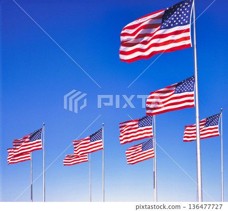 American flag fluttering in the blue sky American flag fluttering in the blue sky 136477727