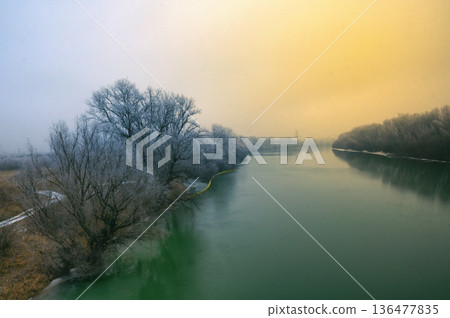 Winter sunrise and fog on Siret river 136477835