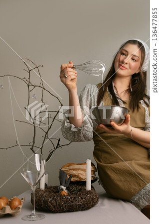 Home Easter preparation woman making white glaze for traditional Easter cake 136477855