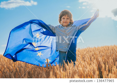 Little Cute Boy With European Union Flag In Field. Happy Handsome Child, Kid, Eu Little Cute Boy With European Union Flag In Field. Happy Handsome Child, Kid, Eu 136477965