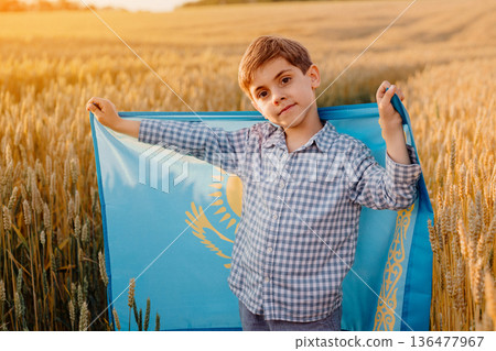 Little Boy Standing in Wheat Field Holding National Flag of Kazakhstan Little Boy Standing in Wheat Field Holding National Flag of Kazakhstan 136477967