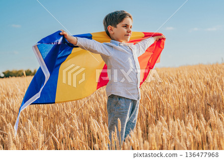 Romanian Little Boy Standing In Golden Wheat Field Holding Romania National Flag 136477968