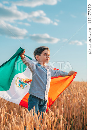 Mexican Little Boy Waving Mexico National Flag In Wheat Field. Latin America Mexican Little Boy Waving Mexico National Flag In Wheat Field. Latin America 136477970