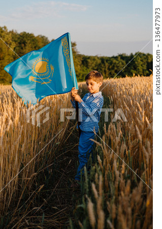 Little Boy Standing in Wheat Field Holding National Flag of Kazakhstan Little Boy Standing in Wheat Field Holding National Flag of Kazakhstan 136477973