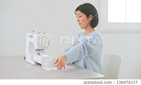 Sewing machine woman image 136478157