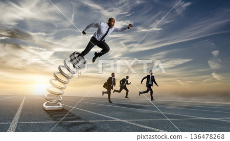 Businessmen run on a racetrack with a spring, showcasing energy and speed at sunset 136478268