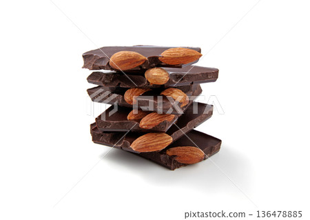 Pieces of dark chocolate with almonds in a stack isolated on white background. Pieces of dark chocolate with almonds in a stack isolated on white background. 136478885