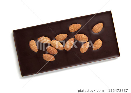 A bar of dark chocolate with whole almonds isolated on a white background. A bar of dark chocolate with whole almonds isolated on a white background. 136478887