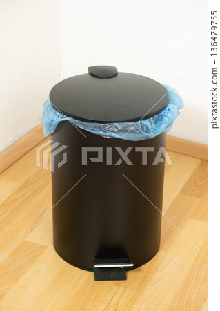 Black Pedal Trash Can with Blue Garbage Bag Indoors Black Pedal Trash Can with Blue Garbage Bag Indoors 136479755