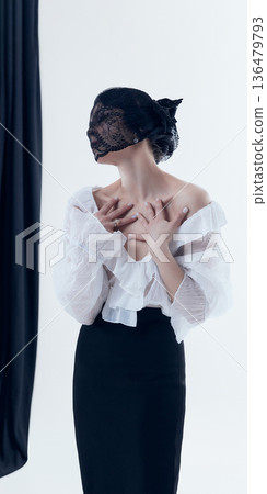 Poetcore inspired woman touching collarbone in romantic studio portrait. Poetcore inspired woman touching collarbone in romantic studio portrait. 136479793