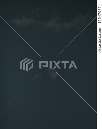 The moon behind the clouds in the blue sky Autumn sky The moon behind the clouds in the blue sky Autumn sky 136479834