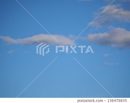 The moon behind the clouds in the blue sky Autumn sky The moon behind the clouds in the blue sky Autumn sky 136479835