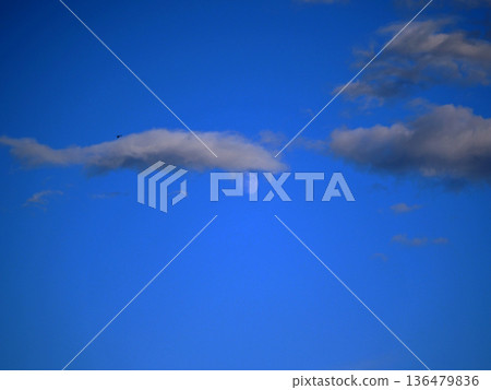 The moon behind the clouds in the blue sky Autumn sky The moon behind the clouds in the blue sky Autumn sky 136479836