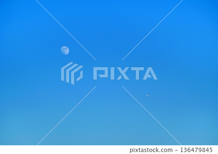 The moon behind the clouds in the blue sky Autumn sky The moon behind the clouds in the blue sky Autumn sky 136479845