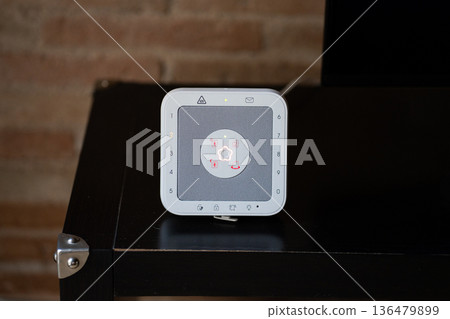 Modern home security control panel displaying smart alarm system with keypad technology, ensuring domestic safety and sophisticated protection for contemporary living space 136479899