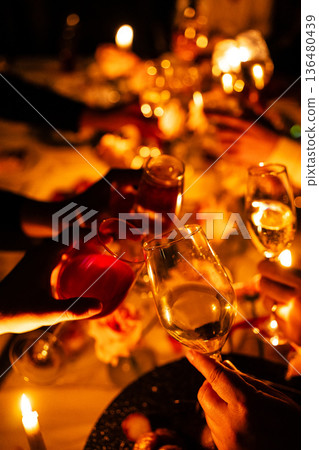 Celebration with toast glasses at festive table gathering Celebration with toast glasses at festive table gathering 136480439