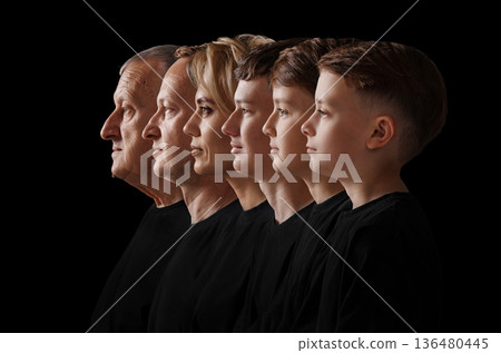 Family members show their profiles in a line against a black background 136480445